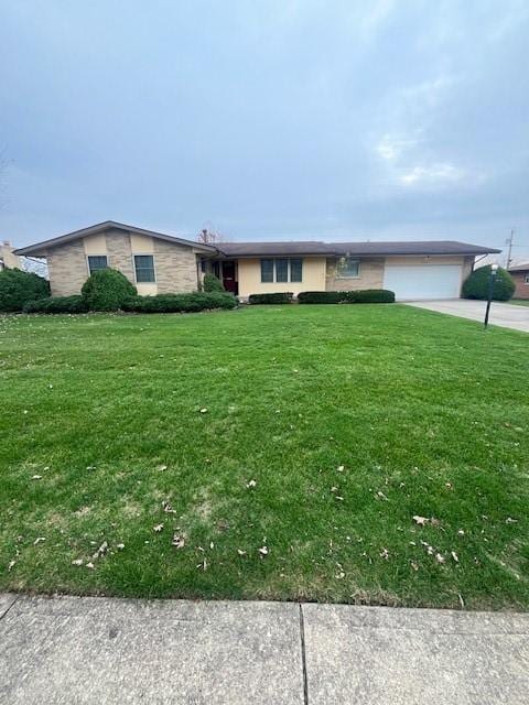 ranch-style house with a garage and a front lawn