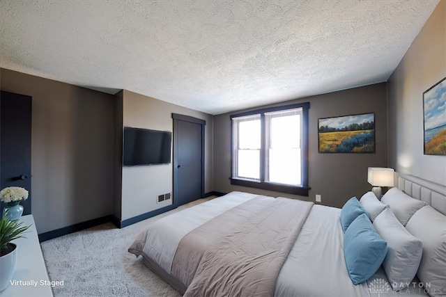 carpeted bedroom with a textured ceiling