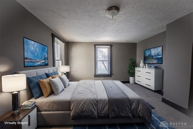 bedroom with carpet and a textured ceiling