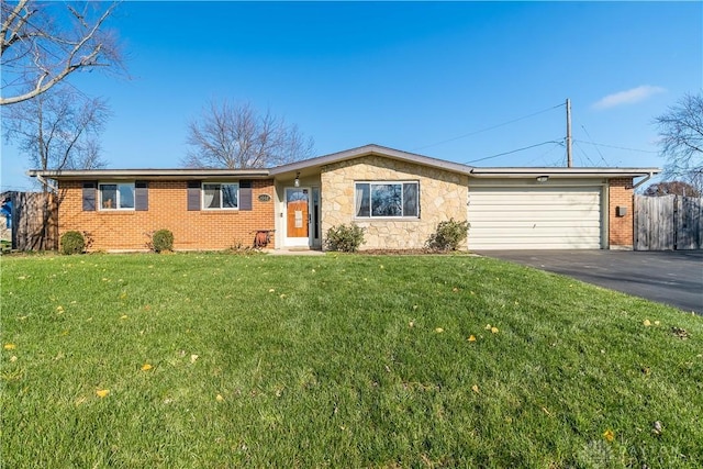 ranch-style home with a garage and a front yard