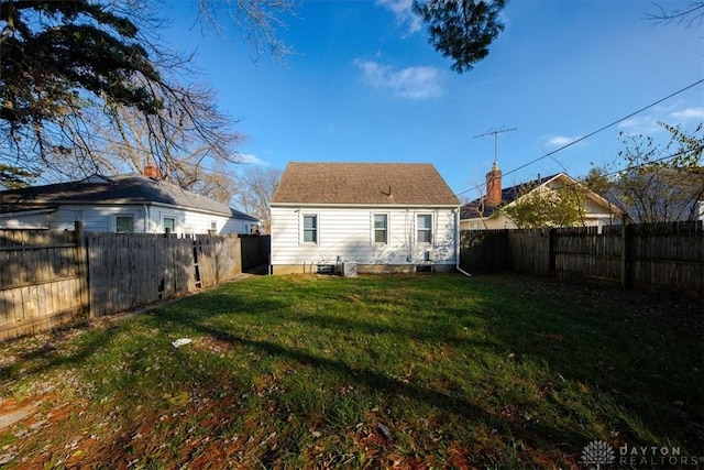 rear view of property with a lawn