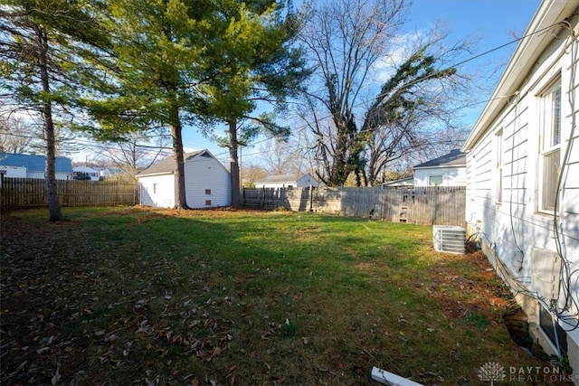 view of yard featuring central air condition unit and an outbuilding