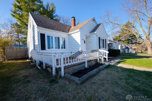 view of front facade with a front yard and a deck