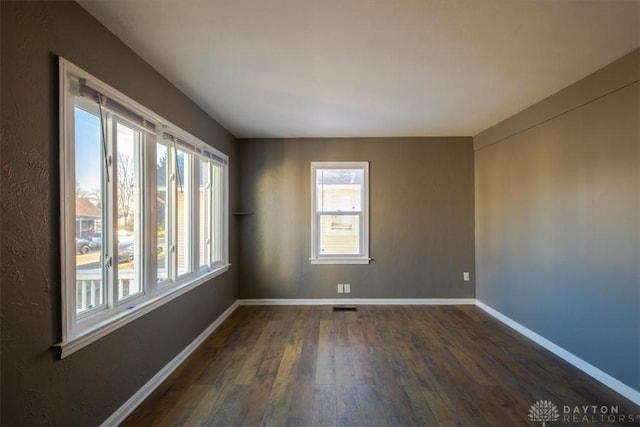 spare room with dark hardwood / wood-style flooring