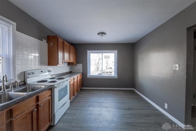 kitchen with backsplash, white range with electric stovetop, sink, and dark wood-type flooring