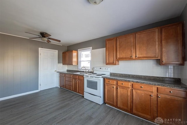 kitchen with tasteful backsplash, sink, white electric range oven, and dark hardwood / wood-style floors