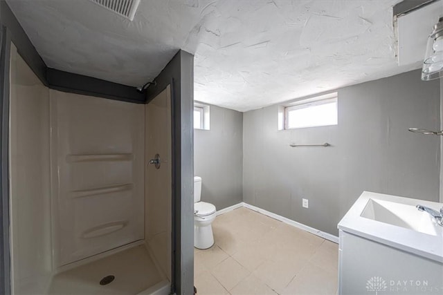 bathroom featuring vanity, toilet, and walk in shower