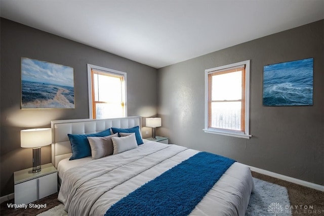 carpeted bedroom featuring multiple windows