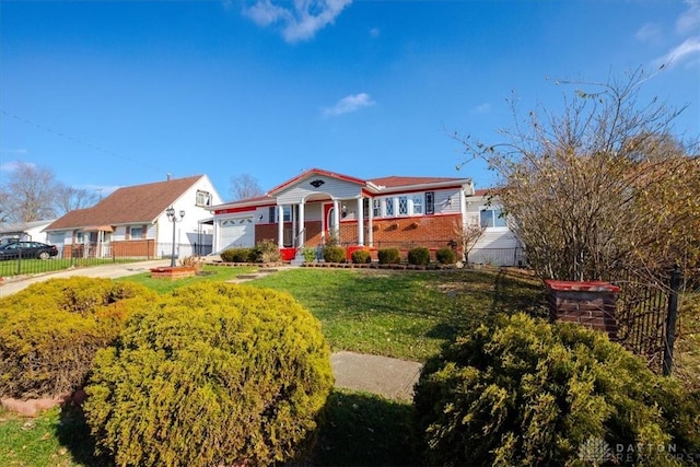 view of front of home featuring a front yard and a garage