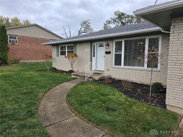 doorway to property featuring a yard