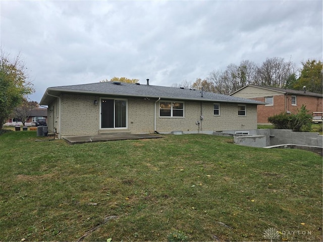 rear view of property with a yard