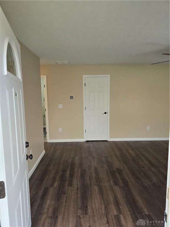 unfurnished room featuring dark hardwood / wood-style flooring