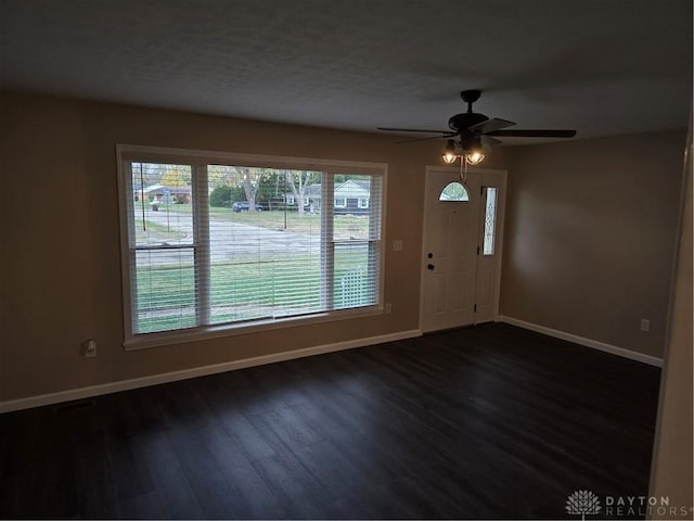 foyer entrance with ceiling fan and dark hardwood / wood-style flooring