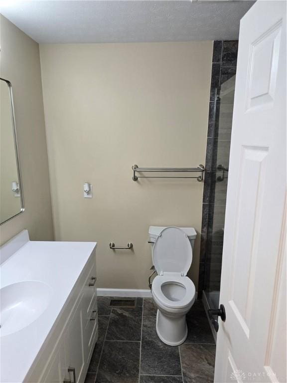 bathroom with walk in shower, tile patterned flooring, vanity, and toilet