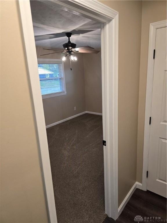 empty room featuring ceiling fan and dark hardwood / wood-style flooring