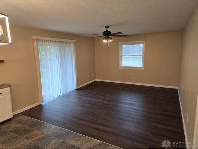 unfurnished room featuring dark hardwood / wood-style floors and ceiling fan