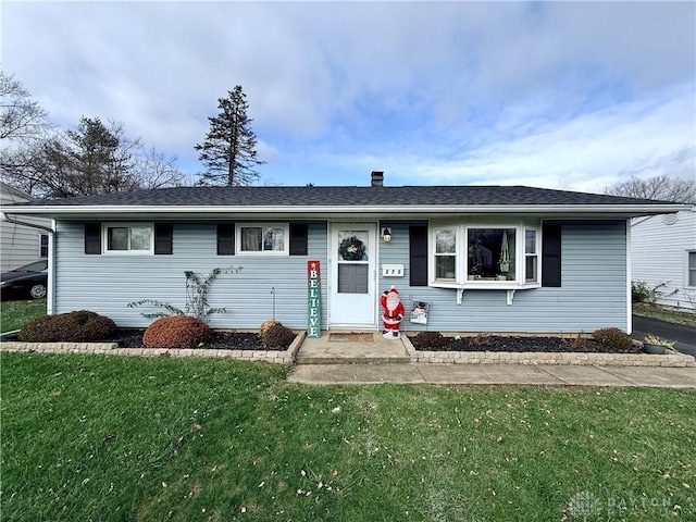 single story home featuring a front lawn