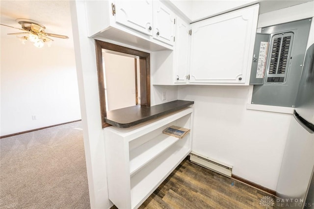 interior space with ceiling fan, a baseboard radiator, and wood-type flooring