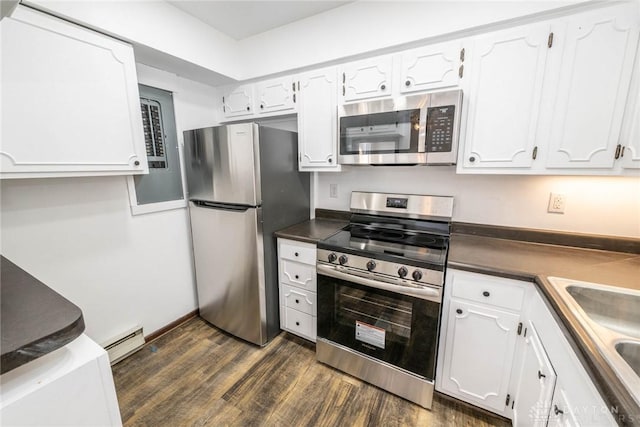 kitchen with appliances with stainless steel finishes, dark hardwood / wood-style floors, white cabinetry, and a baseboard radiator