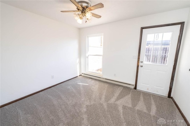 carpeted spare room with baseboard heating and ceiling fan