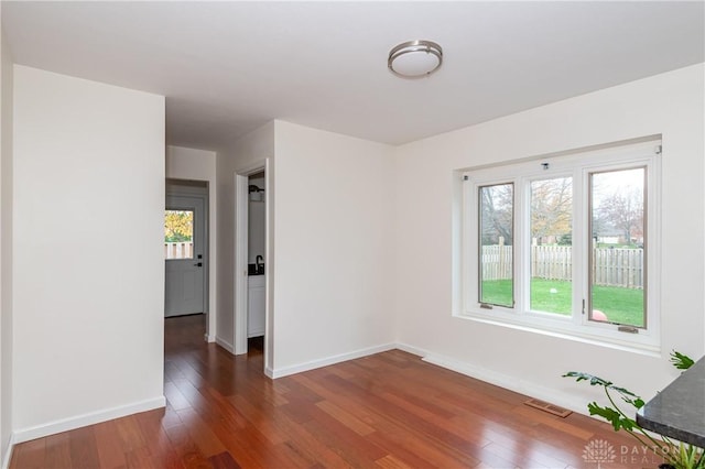 spare room featuring dark hardwood / wood-style flooring