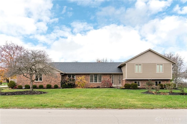 tri-level home with a front lawn