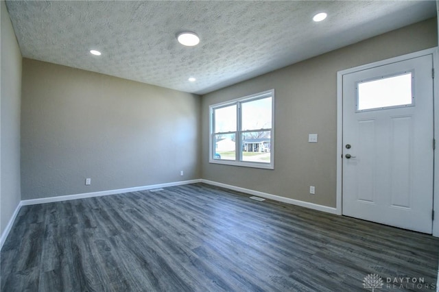 entrance foyer featuring dark hardwood / wood-style floors and a textured ceiling