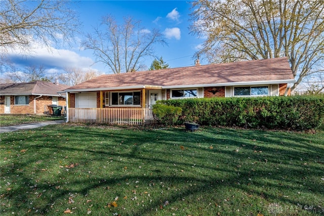 ranch-style home featuring covered porch and a front lawn