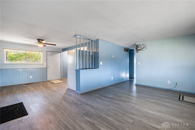 unfurnished living room featuring hardwood / wood-style flooring and ceiling fan