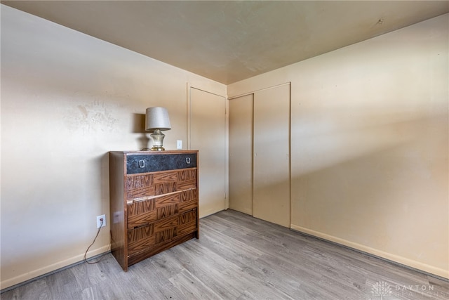 bedroom featuring a closet and light wood-type flooring