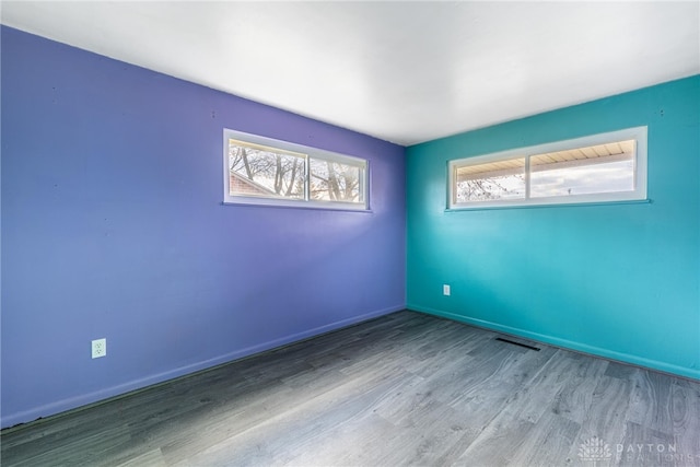 spare room featuring light hardwood / wood-style floors and plenty of natural light