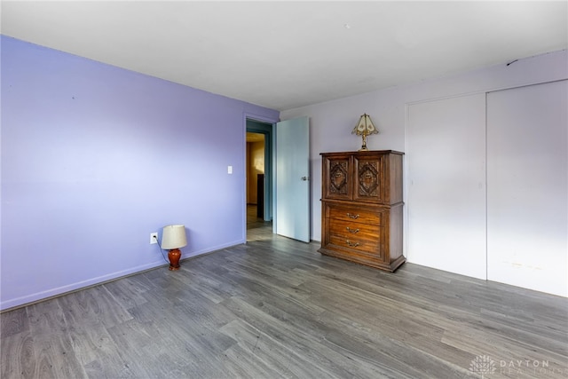 unfurnished room with hardwood / wood-style flooring