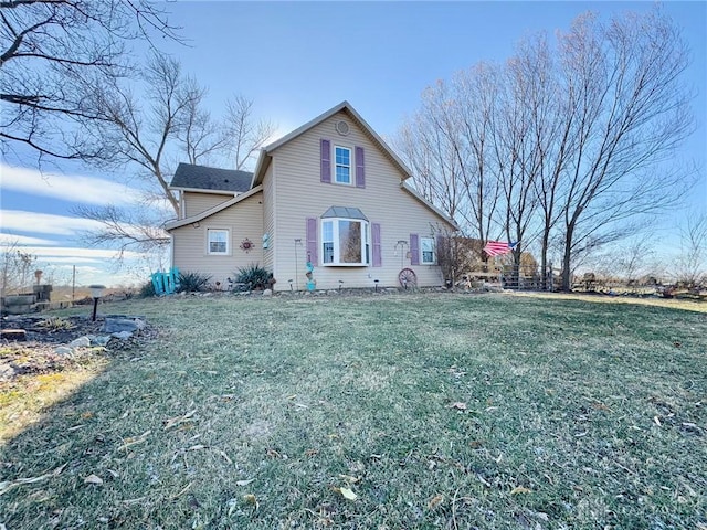 back of house featuring a lawn