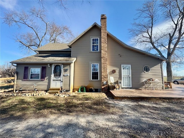 rear view of house featuring a deck