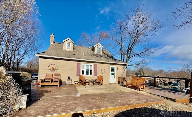 rear view of house featuring a wooden deck