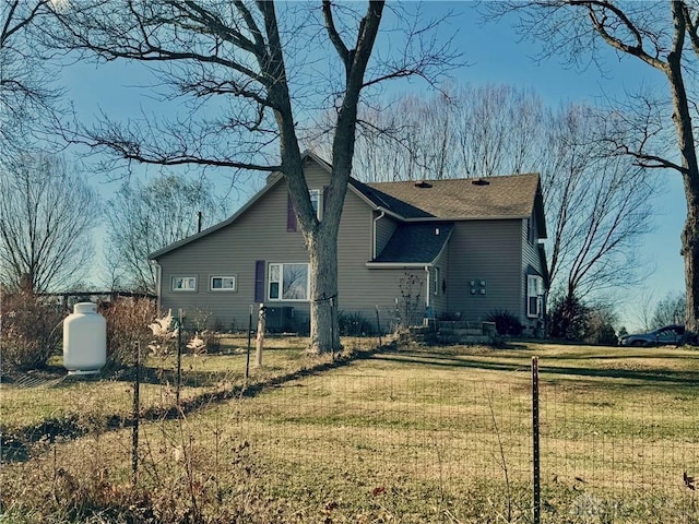 rear view of property featuring a yard