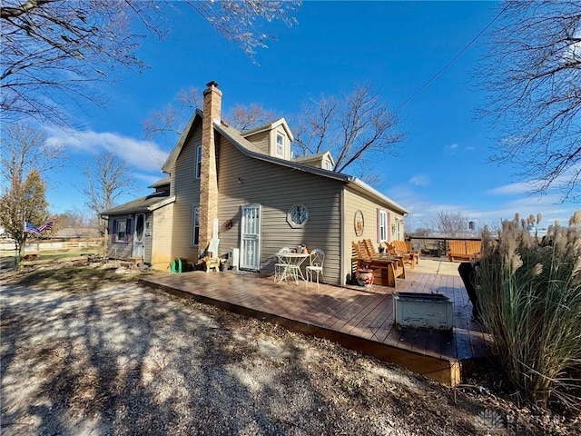 rear view of property featuring a deck