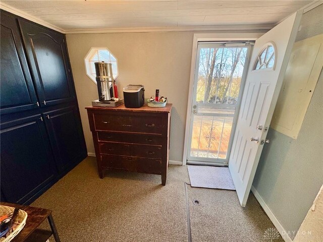 entryway featuring light carpet, crown molding, and wooden ceiling