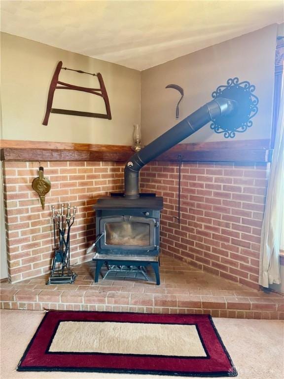 interior details with carpet and a wood stove