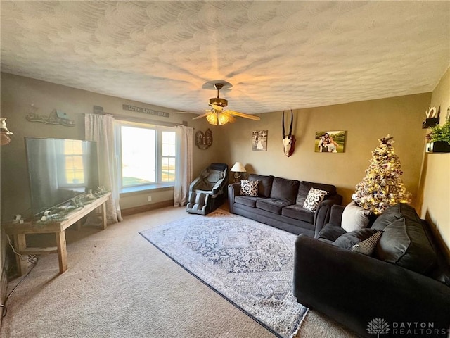 carpeted living room with ceiling fan and a textured ceiling