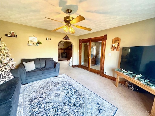 living room featuring carpet and ceiling fan