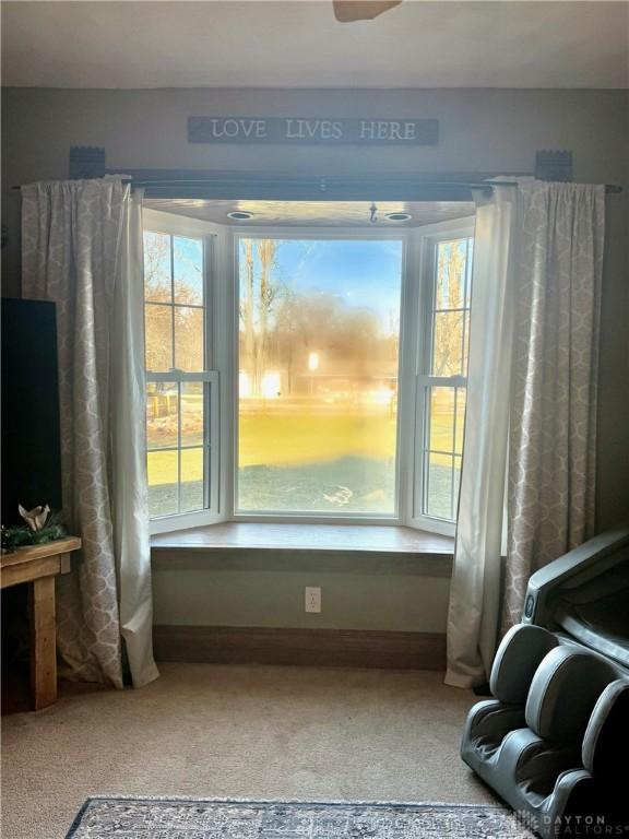 sitting room featuring a healthy amount of sunlight and carpet