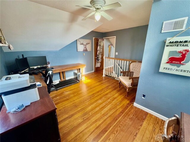 office featuring lofted ceiling, ceiling fan, and wood-type flooring