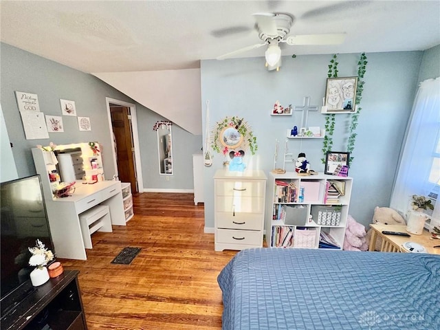 bedroom featuring hardwood / wood-style floors, ceiling fan, and lofted ceiling