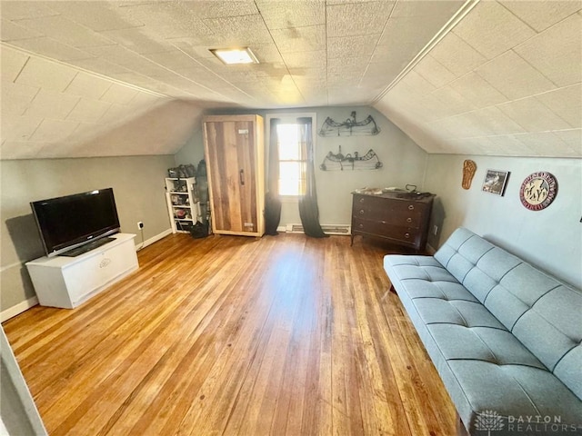 interior space with wood-type flooring and vaulted ceiling