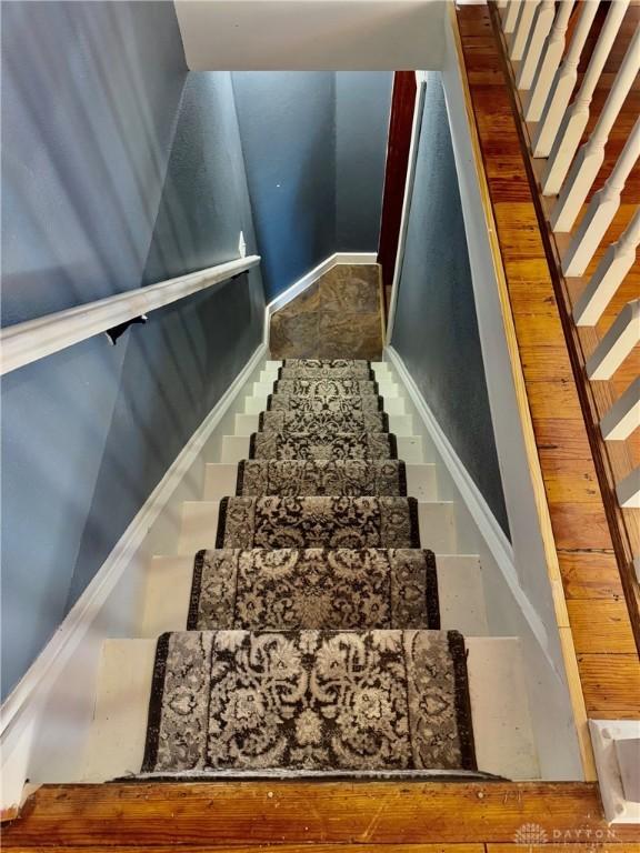 stairs with hardwood / wood-style floors