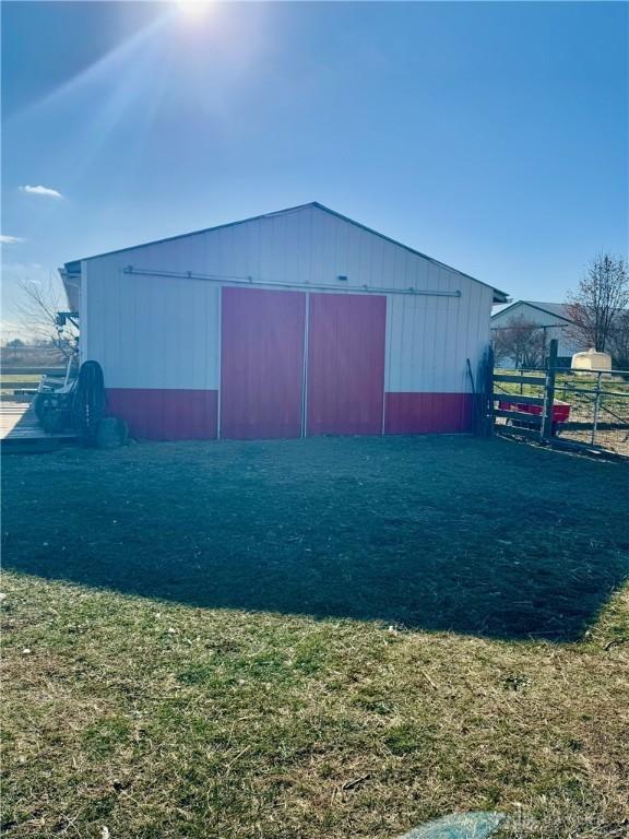 view of outdoor structure featuring a lawn