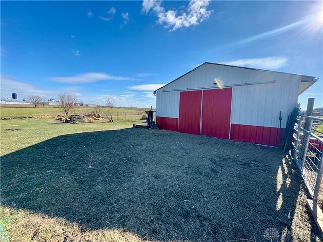 view of outbuilding with a yard and a rural view