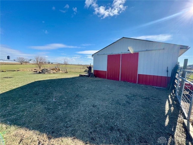 view of outdoor structure featuring a yard and a rural view