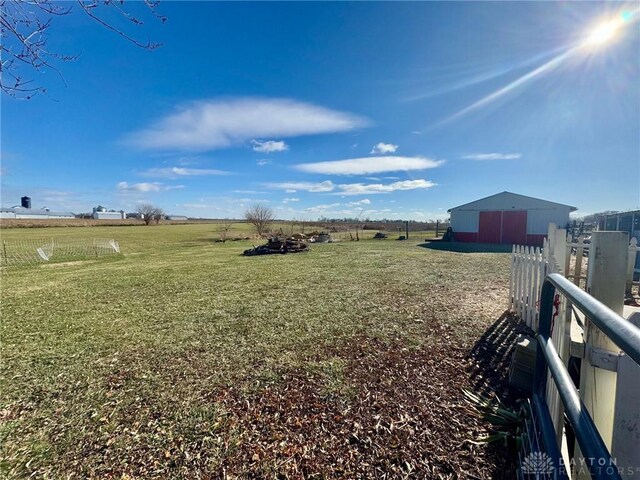 view of yard featuring an outbuilding and a rural view